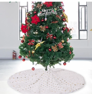 Close-up of white plush Christmas tree skirt with golden sequin patterns for holiday decor