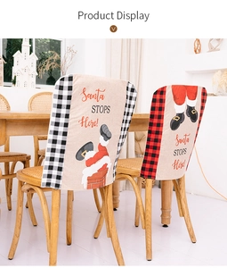 Detail of Christmas chair covers with Santa legs pattern and festive plaid trim decoration