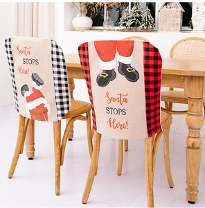 Detail of Christmas chair covers with Santa Stops Here slogan and plaid pattern