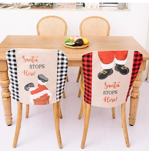 Detail of Christmas chair covers featuring Santa Claus designs in plaid patterns