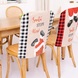Christmas plaid chair covers with Santa Claus and Santa Stops Here festive text