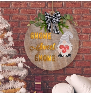 Close-up of wooden GNOME Sweet GNOME door hanger with buffalo plaid bow and greenery