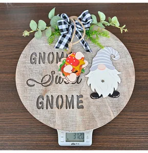 Close-up of wooden GNOME Sweet GNOME door hanger with buffalo plaid bow and green foliage