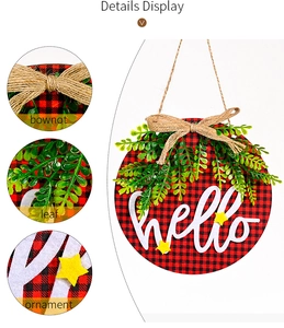 Detail of buffalo plaid Christmas sign with linen bowknot and green fern leaves