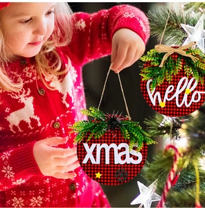 Close-up of wooden Christmas door sign with red plaid pattern and hello xmas text