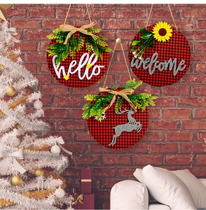 Three-piece buffalo plaid Christmas door signs with greenery, hello and welcome scripts