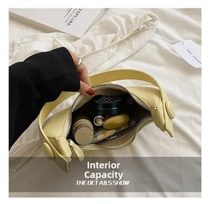 Interior view showing the large capacity of this cream yellow crescent shoulder bag