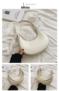 Detail showing white crescent hobo bag with wide shoulder strap and smooth PU leather texture