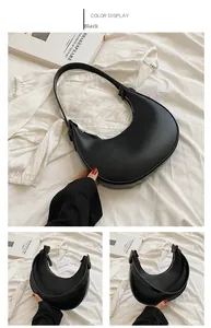 Detail view of black crescent moon shoulder bag with smooth texture and sleek strap