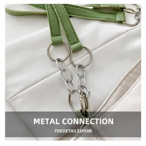 Close-up of mint green leather strap with silver metal rings and thick chain link
