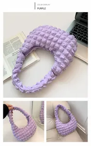 Detail of purple ruched cloud bag with bubble texture and crescent moon silhouette