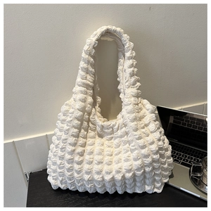 Close-up of white popcorn fabric texture on a large capacity pleated tote bag