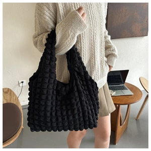 Detail of black bubble texture tote bag with stylish pleated fabric and large capacity