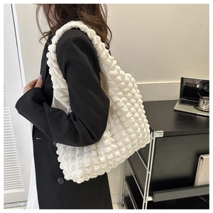Close-up of white bubble texture fabric on a large capacity shoulder tote bag
