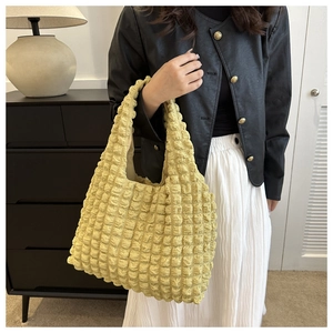 Detail of trendy yellow cloud bubble textured fabric on a stylish casual tote bag