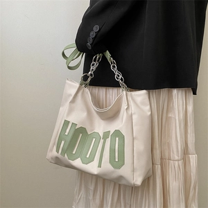 Minimalist beige PU leather tote bag with green HOOTO lettering and silver chain strap