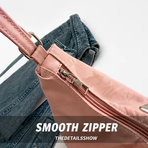 Detail of silver zipper and pink faux leather texture on minimalist large shoulder bag