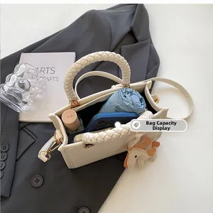 Interior view of white woven tote bag showing large capacity for umbrella and cosmetics