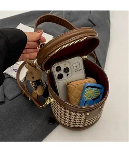 Internal view of houndstooth bucket bag showing capacity for phone and card holder