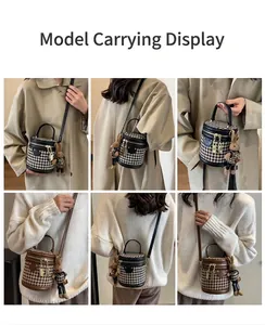Detail view of houndstooth cylinder bucket bag with leather trim and rabbit charm