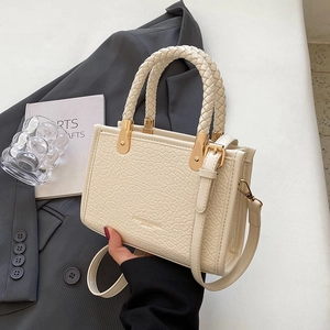 Chic beige crocodile texture tote bag with woven handles and gold metal hardware