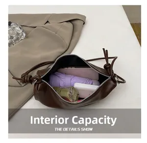 Interior detail of brown faux leather shoulder bag showing large storage capacity