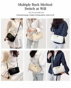 Detail of minimalist leather crossbody bag with golden square lock and slim shoulder strap