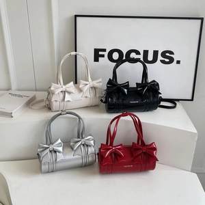 Elegant bow cylinder shoulder bags in white, black, silver and red leather finish