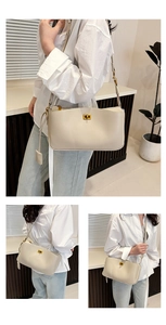 Detailed view of beige Kelly style handbag with gold buckle and adjustable strap