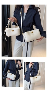 Close-up of white leather handbag with golden twist lock and adjustable shoulder strap