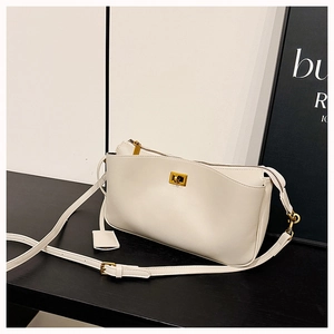 Detail of off-white leather shoulder bag featuring gold square twist lock and sleek zipper