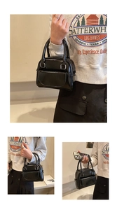 Close-up of black glossy patent leather mini Boston bag with silver hardware and dual handles