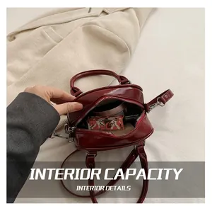 Interior view showing capacity for makeup inside a red patent leather round handbag