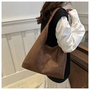 Brown suede tote bag shown on shoulder for daily commute with large capacity