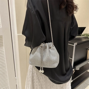 Sparkling silver rhinestone bucket bag with drawstring pearls and metal chain strap