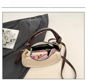 Top view of cream crescent bag interior showing spacious storage for wallet and makeup
