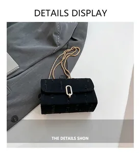 Detail view of denim crossbody bag with textured fabric and golden chain strap