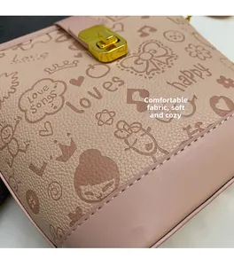 Close-up of pink litchi grain leather with cute cartoon prints and gold metal buckle