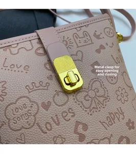 Close-up of pink embossed leather bag with heart patterns and gold turn-lock hardware