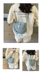 Detail of light blue graffiti bucket bag with black hand-drawn heart and music note motifs