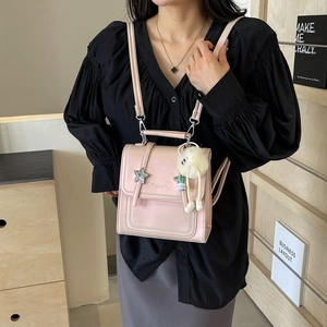 Pink PU leather backpack with star charm and plush ball for women crossbody use
