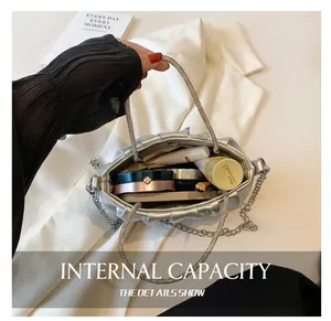 Interior view showing capacity of silver pleated cloud bag with metal chain strap