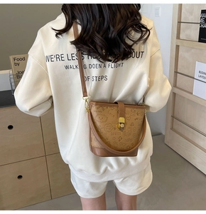 Brown PU leather bucket bag with cartoon graffiti embossing and golden metal lock
