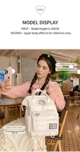 White minimalist multi-pocket backpack for students shown in a cozy cafe setting