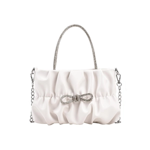 White pleated bucket bag with rhinestone bow and sparkling diamond handle with silver chain