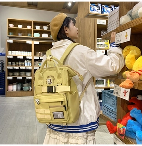 Close-up of yellow waterproof nylon school backpack with buckle and zipper details