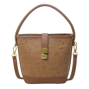 Brown bucket bag with embossed cartoon graffiti patterns and gold metal lock hardware