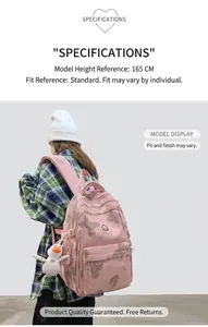 Pink printed backpack with cartoon bears and plush duck pendant shown on female model