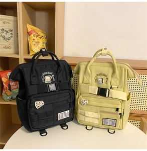 Detail view of the backpack showing black and yellow colors with KEKEMI logo and bread print