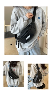 Detail der schwarzen Brusttasche mit SUNIAN-Logo und gewebter Reißverschlusskordel